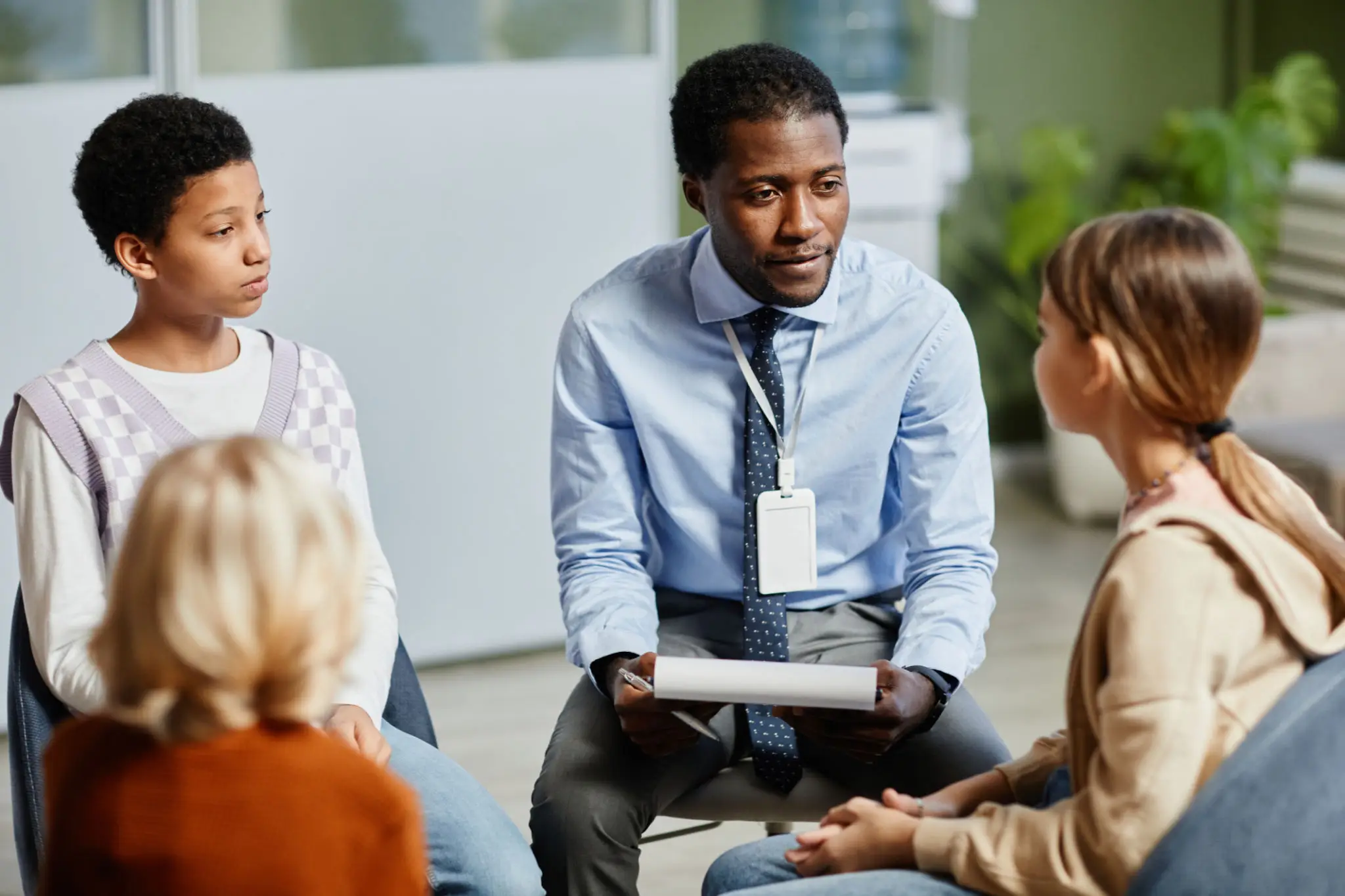 School counselor meeting with three students